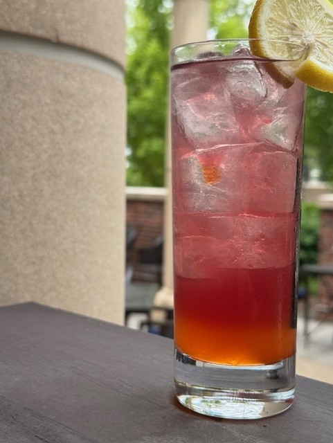 Orange cocktail with a lemon garnish