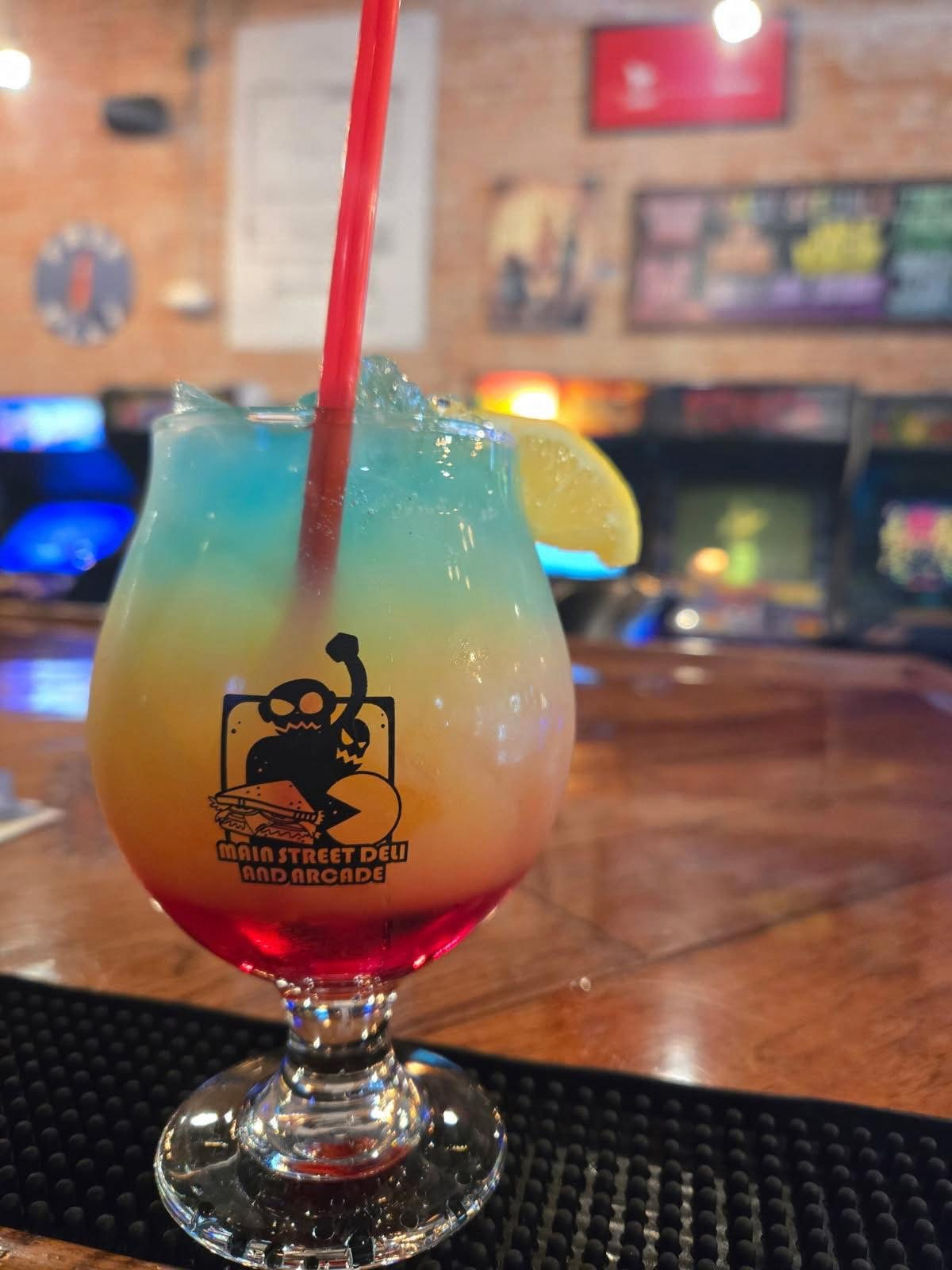 Drink in a Main Street Deli and Arcade glass with blue, yellow and red layers